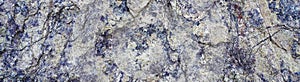 Texture of natural stone rock, background wallpaper white, blue and violet blotches on the surface. Horizontal