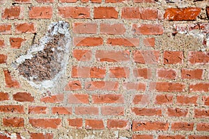 The texture of the old ancient medieval antique stone hard peeling cracked brick wall of rectangular red clay bricks and large