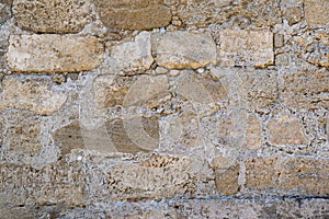 Texture of an old and ancient stone wall closeup