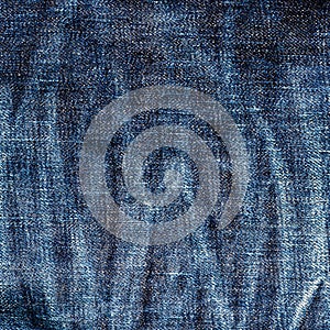 Texture of old blue jeans textile close up with fade