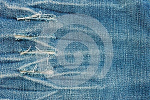 Texture of old blue jeans at torn