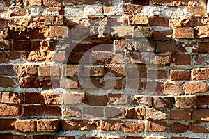 Texture of an old brick wall. Chipped bricks.