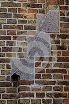 Texture of old brick wall with multicolored bricks and decoratieve steps