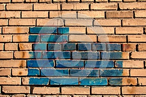Texture of old colored bricks. Close-up of a red and green brick wall with painted bricks. Horizontal background with free space
