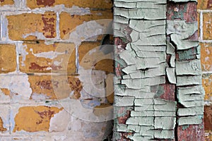 The texture of the old cracked wood, painted in blue on a background of an old brick wall.