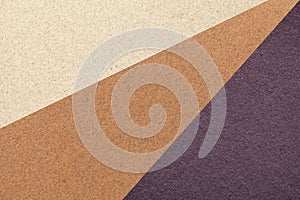 Texture of old craft beige, brown and dark violet color paper background, macro. Structure of vintage abstract cardboard