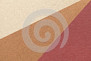 Texture of old craft beige, brown and maroon color paper background, macro. Structure of vintage abstract cardboard