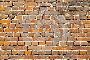 Texture of an old damaged brick wall with a big crack in it