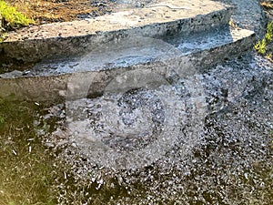 Texture of old gray concrete crumbling broken stone steps. The background