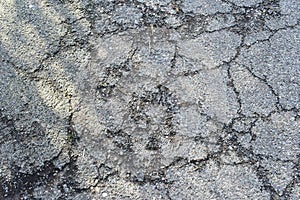 Texture of old gray cracked asphalt.