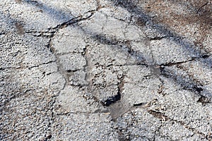 Texture of old gray cracked asphalt.