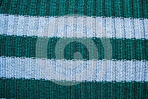 Texture of old green and blue striped knitted sweaters. Double ribbing stitch knit fabric background
