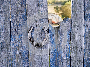 Texture of old iron horseshoe and wooden surface of the gate