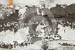 Texture of old light wall with peeling white paint