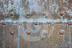 Texture of old metal door with rivets