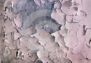 The texture of the old paint peeling on the stone wall. Background of exfoliation dye.