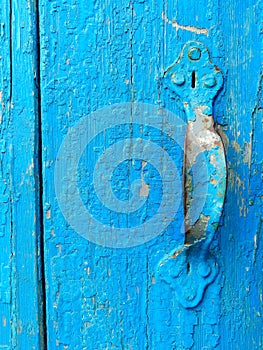 texture of old painted shabby rustic wooden fence made of planks, with rusty nails, hand-forged iron elements, grunge background