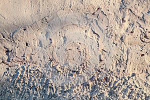 Texture of old plastered pink wall with with influxes and cracks