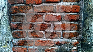 texture of Old red brick wall. Peeling plaster from walls