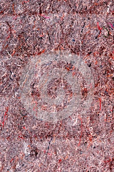 Texture of old red felt fabric, background of material with pile and threads