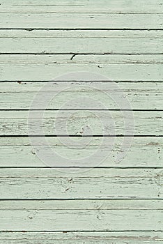 The texture of old scratched green wooden planks. Old painted wood wall texture.