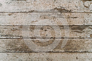 The texture of old scratched wood. Gray, worn paint on the wooden surface. Shabby wall background