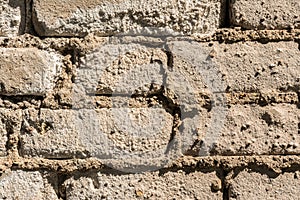 Texture of the old wall of brick blocks, scattered brick and brickwork, architecture abstract background
