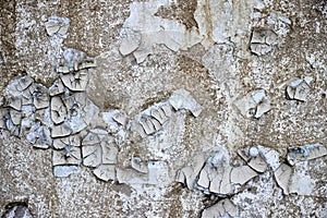 texture of old wall with scuffed plaster and peeling of paint