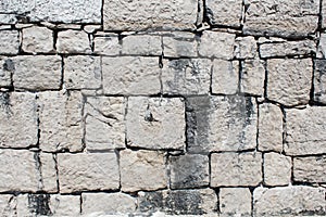 Texture of old wall from squared stone bricks