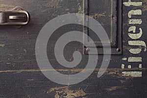 Texture of an old wooden case for military equipment with metal fittings and a part of a stencilled german word