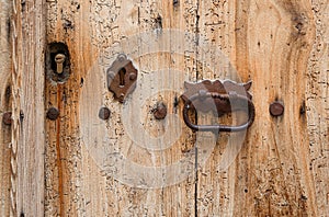 Texture of old wooden door with keyholes and handle