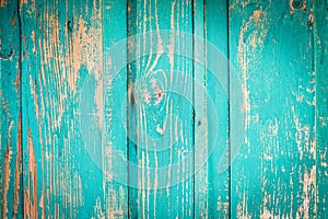 Texture of an old wooden turquoise door. the blue paint is peeling, cracked. vintage texture, background for your text