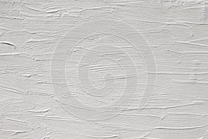 The texture of the paint is white. Wall background with plaster and stains.