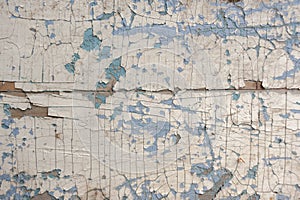 Texture, pattern, background old paint. the wooden wall cracked with paint. With a white tinge, the paint eventually