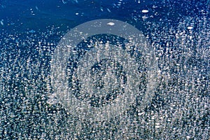 Texture pattern background white Winter, river ice air bubbles stagnant. drawing on ice frost formed. Severe cold frozen water. a