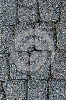 The texture of paving stone masonry, close up, top view. Exterior floor covering. Pavement background