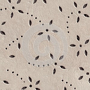 Texture of perforated genuine leather, embossed floral pattern. Modern background