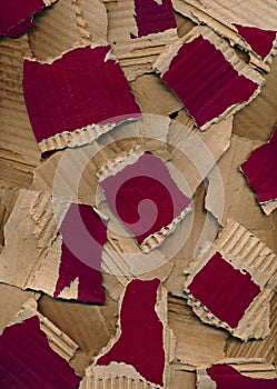 Texture from pieces of torn colored cardboard. Red brown carton background. Recycling concept. Rough pieces of ripped corrugated