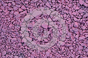 Texture of a pile of crushed stones, painted in pink