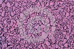 Texture of a pile of crushed stones, painted in pink