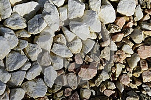 Texture of pile of white and darker decorative stones, diagonal boundary