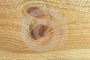 The texture of a pine board with a knot in the middle, after mechanical processing. Background image.