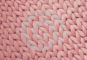 Texture of pink knit blanket. Large knitting. Plaid merino wool. Top view