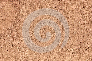 Texture of a plasterwork painted in beige used as an exterior coating on a building