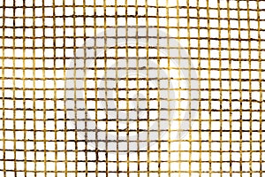 Texture of a plastic grid of yellow color on a white background. Mosquito net background