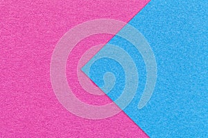 Texture of purple and blue paper background, half two colors with arrow, macro. Structure of craft magenta cardboard