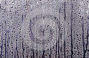 Texture of rain drops on a glass wet transparent surface