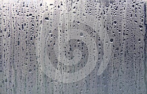 Texture of rain drops on a glass wet transparent surface