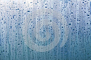 Texture of rain drops on a glass wet transparent surface