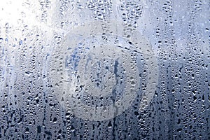 Texture of rain drops on a glass wet transparent surface